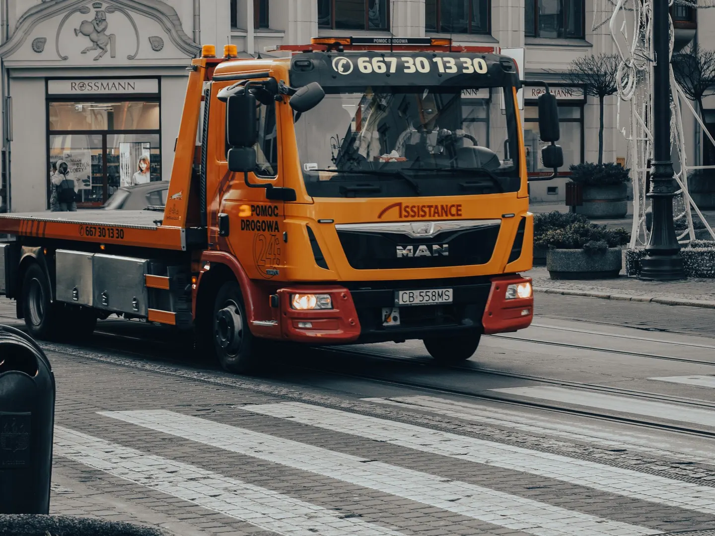A yellow flatbed truck parked on a street
