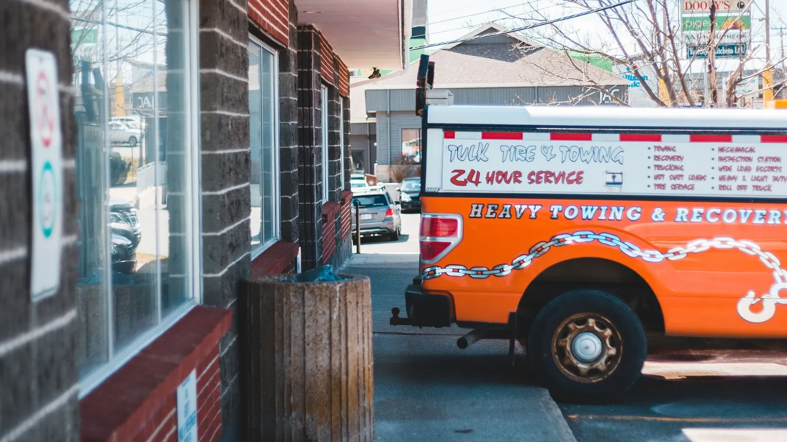 A tow truck parked outside a building