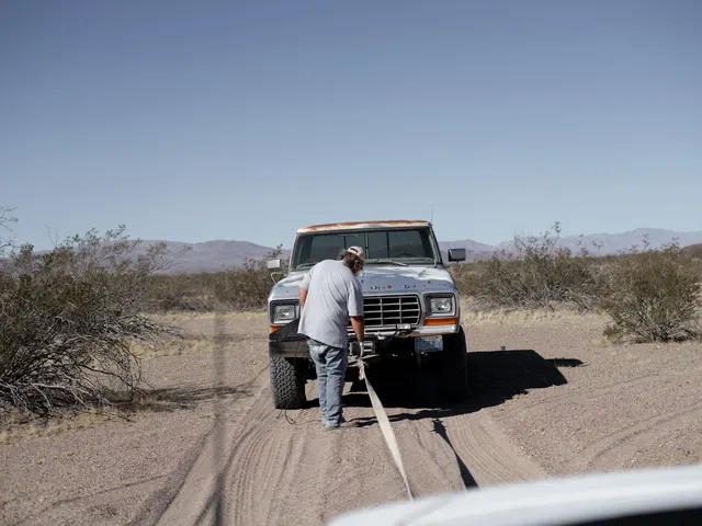 A pickup truck being towed on an open road