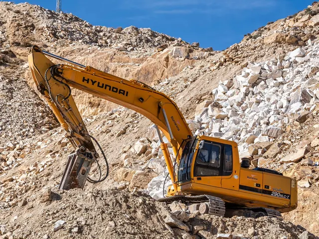A yellow excavator working in a rocky quarry