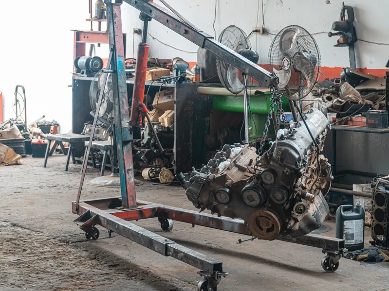 A car engine lifted on a chain hoist